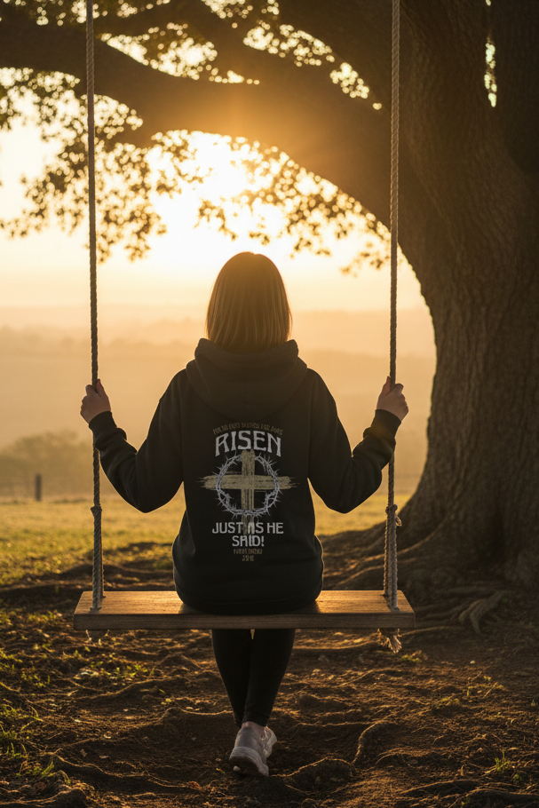 Woman on swing at sunrise wearing Risen hoodie